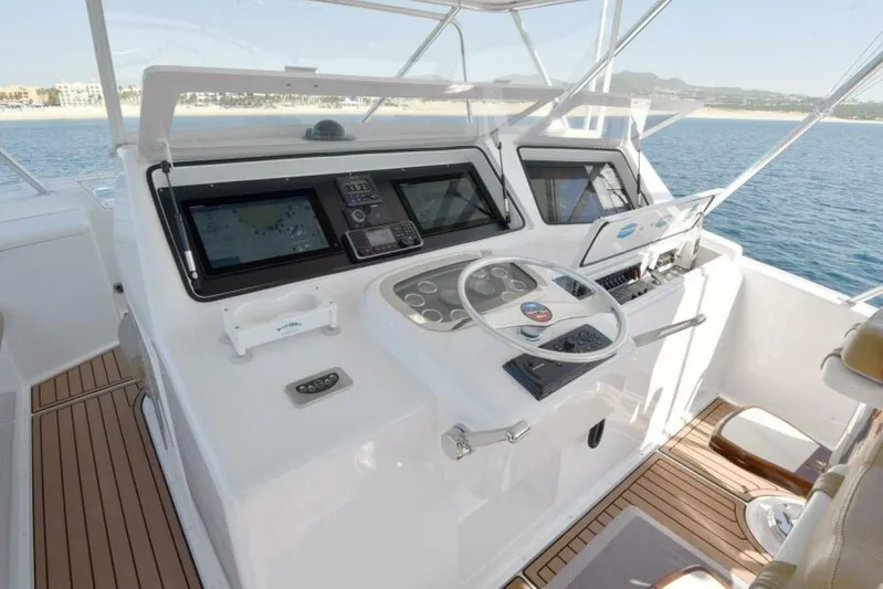 Happy Ending Yacht Photos Pics Cockpit of 2000 Viking 55 Convertible yacht with modern navigation equipment and ocean view.