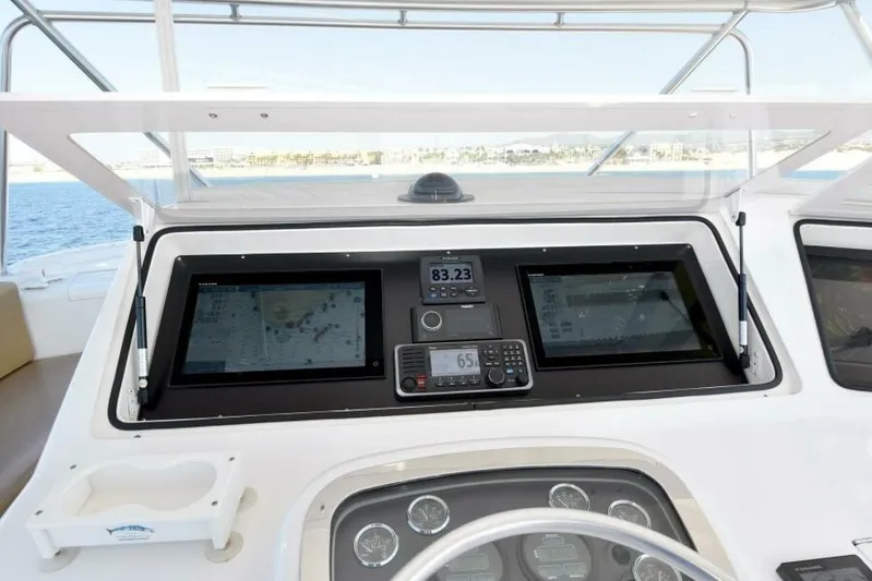 Happy Ending Yacht Photos Pics Control panel of a 2000 Viking 55 Convertible yacht with navigation screens.