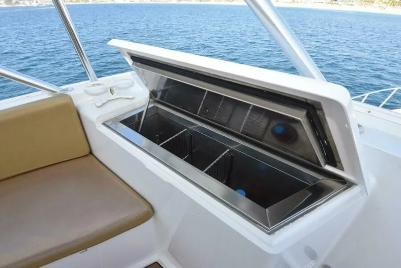 Happy Ending Yacht Photos Pics Open storage compartment on 2000 Viking 55 Convertible yacht, with ocean view in background.