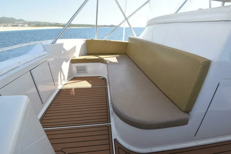 Happy Ending Yacht Photos Pics 2000 Viking 55 Convertible yacht with cushioned seating and ocean view.