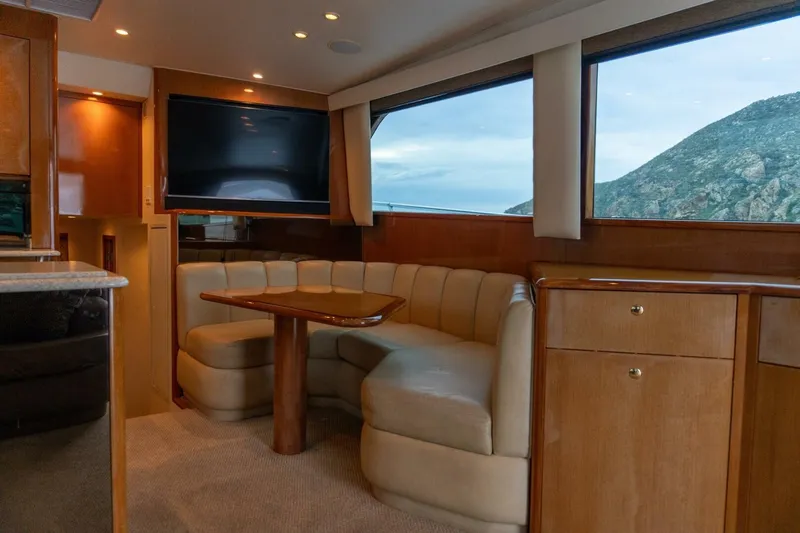 Happy Ending Yacht Photos Pics Luxurious interior of 2000 Viking 55 Convertible yacht with scenic window view.