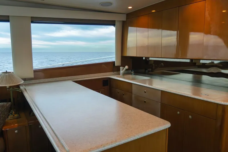 Happy Ending Yacht Photos Pics Luxurious kitchen interior of 2000 Viking 55 Convertible yacht with ocean view.
