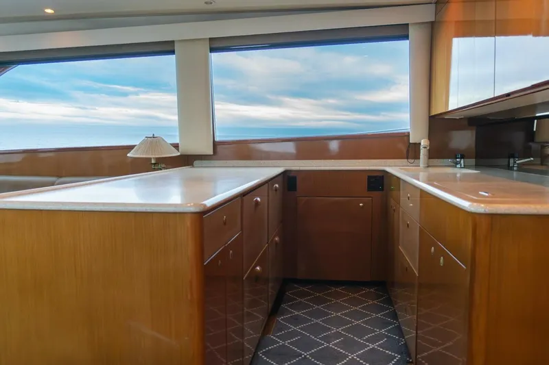 Happy Ending Yacht Photos Pics Interior of 2000 Viking 55 Convertible yacht with wooden cabinetry and ocean view.