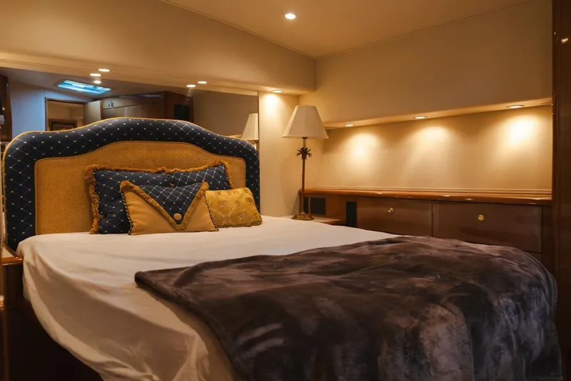 Happy Ending Yacht Photos Pics Luxurious bedroom interior of 2000 Viking 55 Convertible yacht with elegant bedding and lighting.