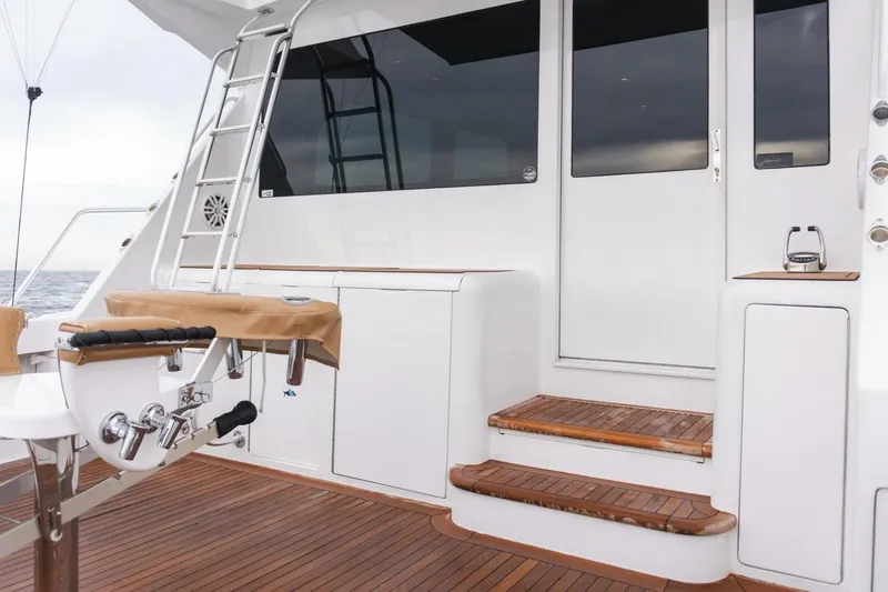 Happy Ending Yacht Photos Pics 2000 Viking 55 Convertible yacht deck with wooden steps and fishing equipment.