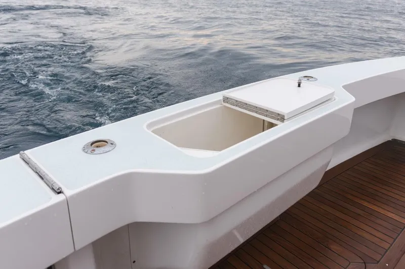 Happy Ending Yacht Photos Pics Viking 55 Convertible 2000 boat deck with open storage compartment, ocean view.