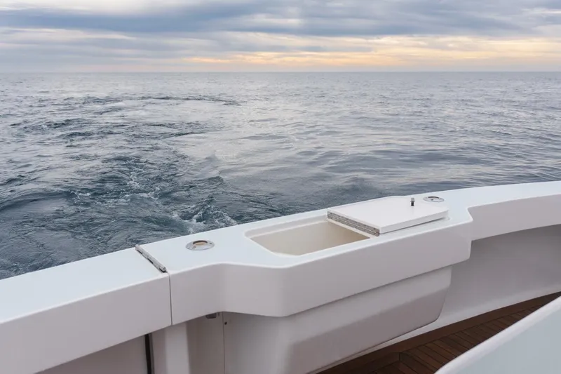 Happy Ending Yacht Photos Pics Viking 55 Convertible 2000 yacht deck overlooking calm ocean at sunset.