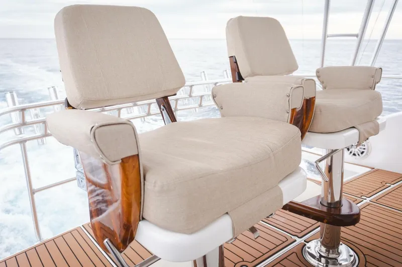 Happy Ending Yacht Photos Pics Luxury seating on 2000 Viking 55 Convertible yacht, featuring beige cushions and wooden accents.