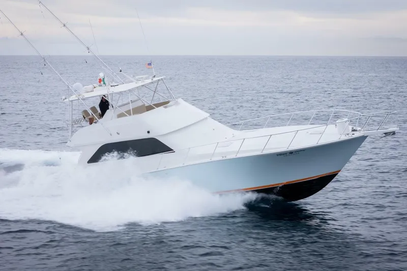 Happy Ending Yacht Photos Pics Viking 55 Convertible 2000 yacht cruising on open sea, creating waves.