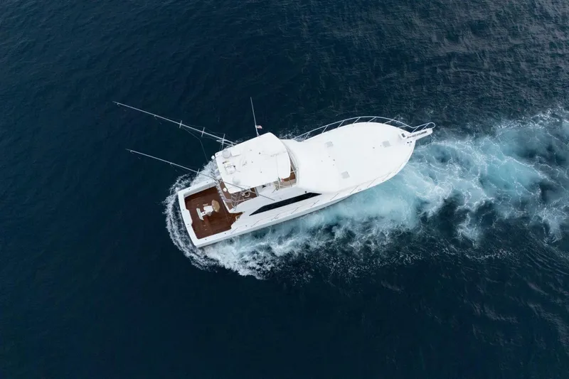 Happy Ending Yacht Photos Pics Aerial view of 2000 Viking 55 Convertible yacht cruising on open water.