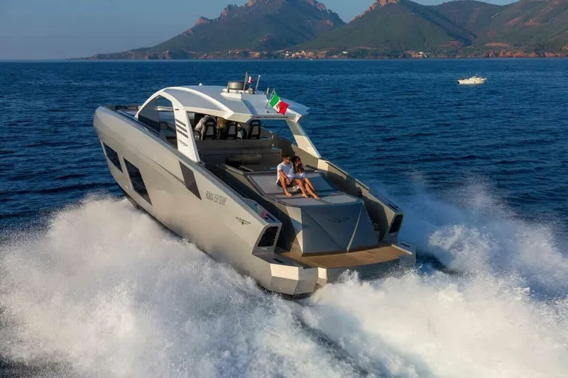  Yacht Photos Pics 2027 Canados GLADIATOR 631 NEXT yacht cruising on open sea with scenic mountain backdrop.