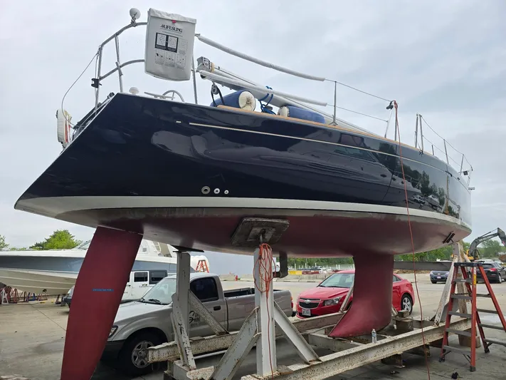 True Blue Yacht Photos Pics Beneteau First 40.7 sailboat from 2000 on a trailer, with visible keel and rudder.