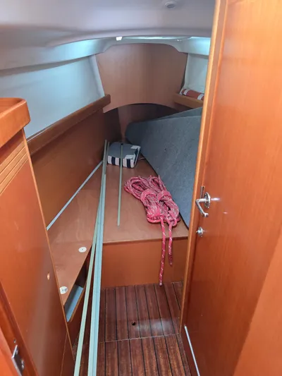 True Blue Yacht Photos Pics Interior cabin of 2000 Beneteau First 40.7 sailboat with wooden finish and red rope.