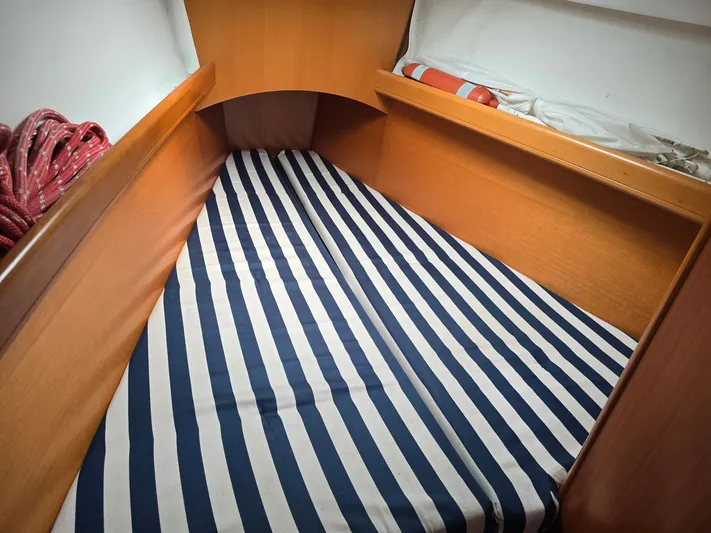 True Blue Yacht Photos Pics Beneteau First 40.7 cabin interior with striped bedding, 2000 model.