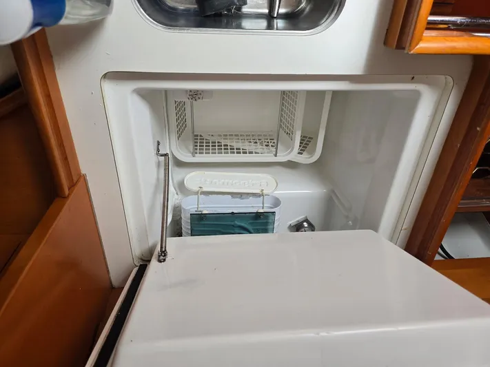 True Blue Yacht Photos Pics Beneteau First 40.7 yacht interior fridge, open with storage compartments, 2000 model.