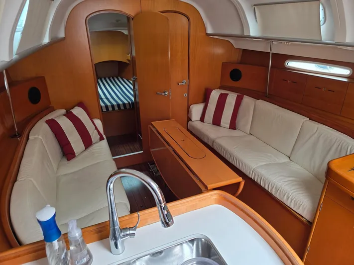 True Blue Yacht Photos Pics Interior of 2000 Beneteau First 40.7 yacht with cozy seating and wooden finishes.