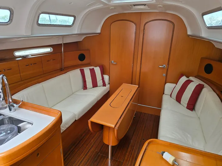 True Blue Yacht Photos Pics Interior of 2000 Beneteau First 40.7 yacht with wood finish and white seating.