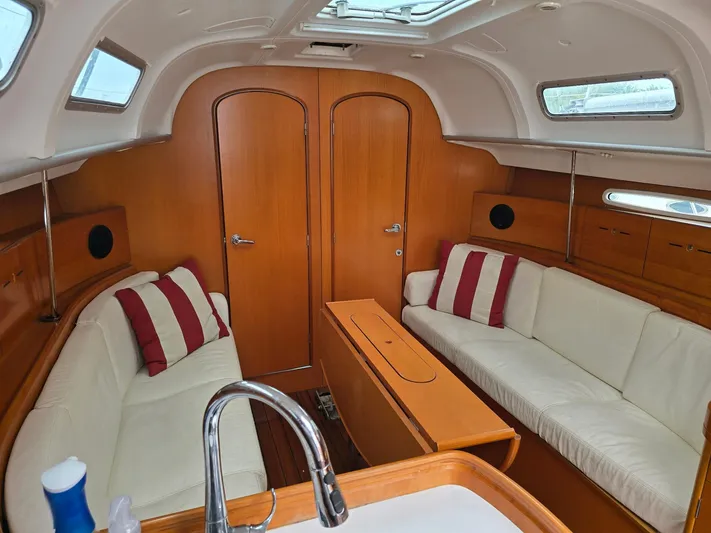 True Blue Yacht Photos Pics Interior of 2000 Beneteau First 40.7 sailboat with cozy seating and wooden finishes.