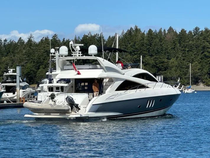 Lai Lani Yacht Photos Pics 2005 Sunseeker Manhattan 66 yacht cruising on a serene lake with forested background.