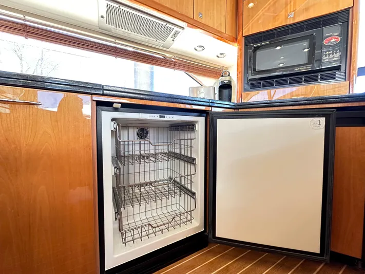 Lai Lani Yacht Photos Pics 2005 Sunseeker Manhattan 66 yacht kitchen with open dishwasher and microwave.