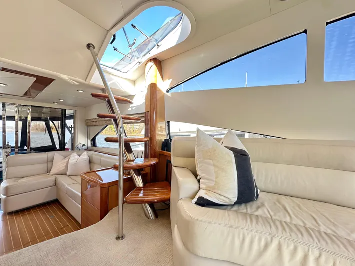 Lai Lani Yacht Photos Pics Luxurious interior of 2005 Sunseeker Manhattan 66 yacht with elegant seating and wooden accents.