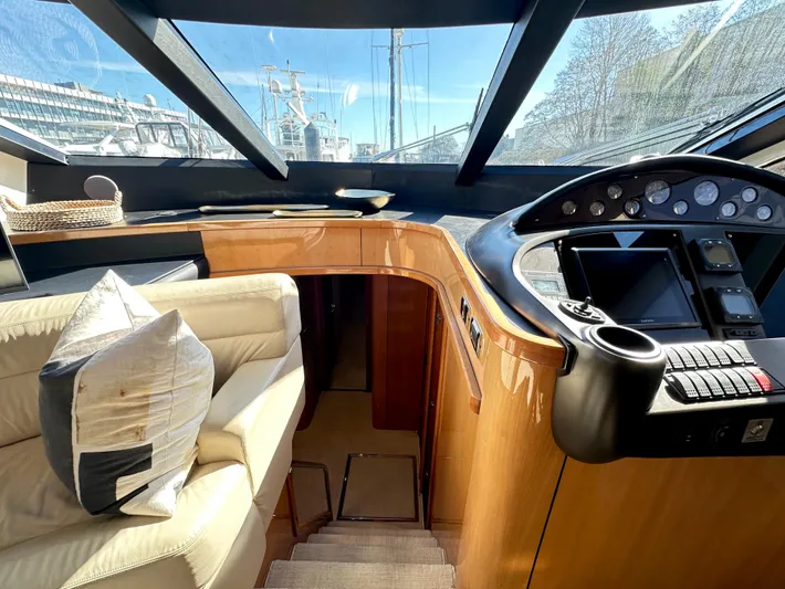 Lai Lani Yacht Photos Pics Luxurious Sunseeker Manhattan 66 yacht interior, featuring a sleek helm and comfortable seating.