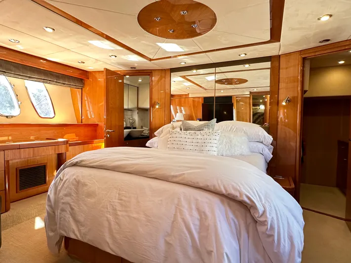 Lai Lani Yacht Photos Pics Luxurious bedroom interior of 2005 Sunseeker Manhattan 66 yacht with elegant wood finishes.