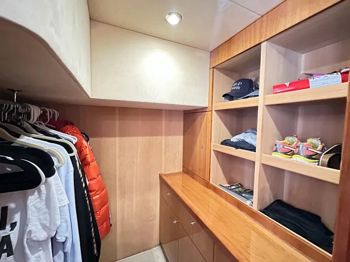 Lai Lani Yacht Photos Pics Walk-in closet on 2005 Sunseeker Manhattan 66 yacht with shelves and hanging clothes.