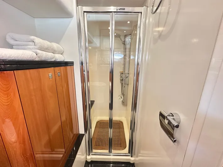 Lai Lani Yacht Photos Pics Shower area in 2005 Sunseeker Manhattan 66 yacht with wooden accents and towels.