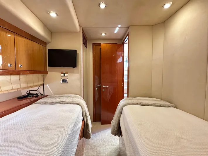 Lai Lani Yacht Photos Pics Luxurious cabin interior of 2005 Sunseeker Manhattan 66 yacht with twin beds and modern amenities.