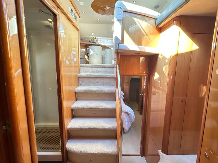 Lai Lani Yacht Photos Pics Interior of 2005 Sunseeker Manhattan 66 yacht, featuring elegant wood finishes and carpeted stairs.