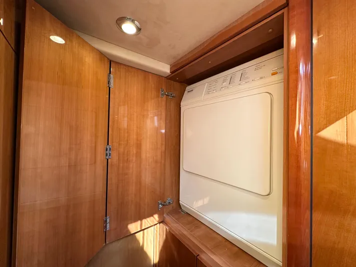 Lai Lani Yacht Photos Pics Laundry area with wooden cabinetry on a 2005 Sunseeker Manhattan 66 yacht.