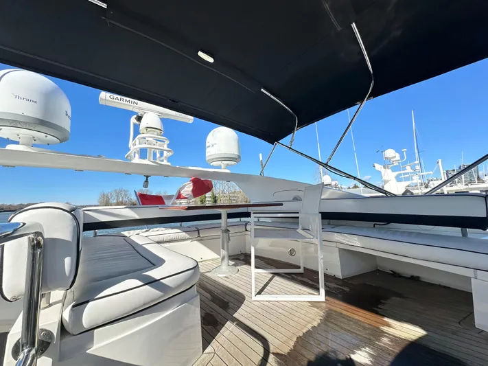 Lai Lani Yacht Photos Pics Sunseeker Manhattan 66 yacht deck with seating, radar equipment, and clear blue sky.