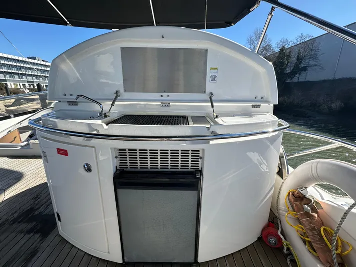 Lai Lani Yacht Photos Pics Outdoor kitchen on a 2005 Sunseeker Manhattan 66 yacht, featuring a grill and storage.