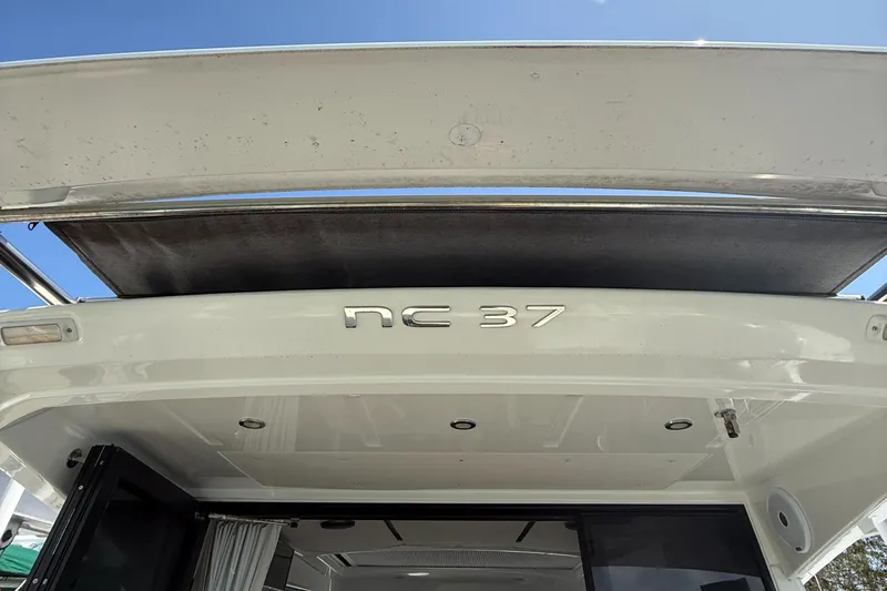  Yacht Photos Pics 2020 Jeanneau NC 37 boat, rear view with open sunroof under clear blue sky.