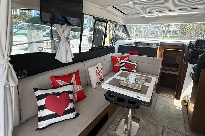  Yacht Photos Pics Interior of 2020 Jeanneau NC 37 yacht with cozy seating and decorative pillows.