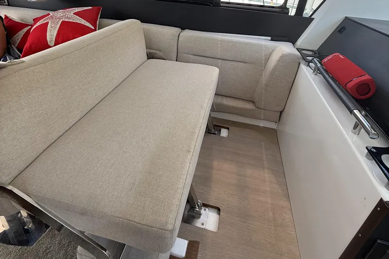  Yacht Photos Pics Interior seating area of 2020 Jeanneau NC 37 boat with beige cushions and decorative pillows.