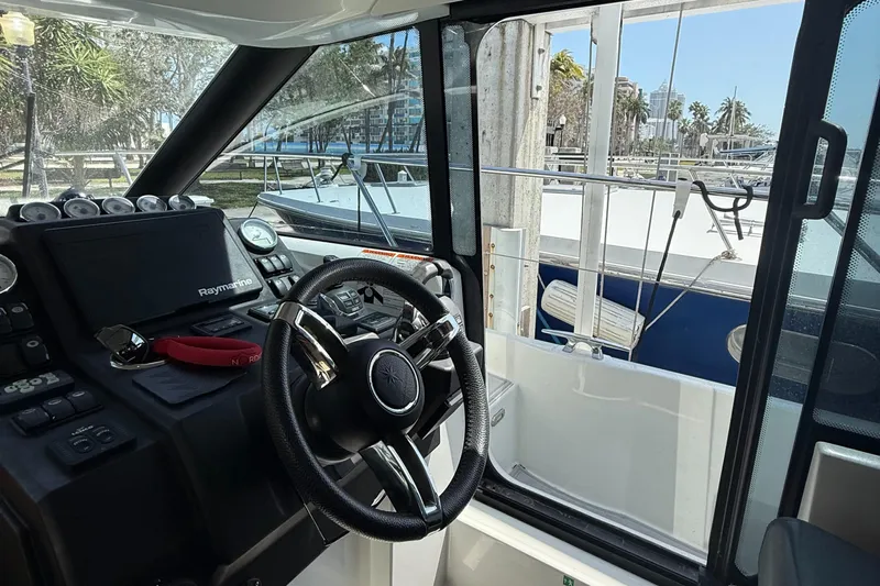  Yacht Photos Pics Interior view of 2020 Jeanneau NC 37 boat cockpit with steering wheel and navigation equipment.