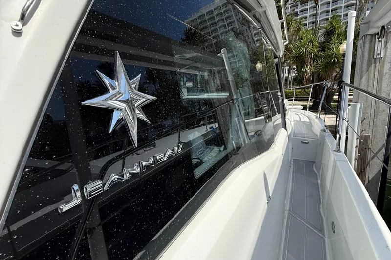  Yacht Photos Pics 2020 Jeanneau NC 37 boat docked, showcasing sleek design and logo.