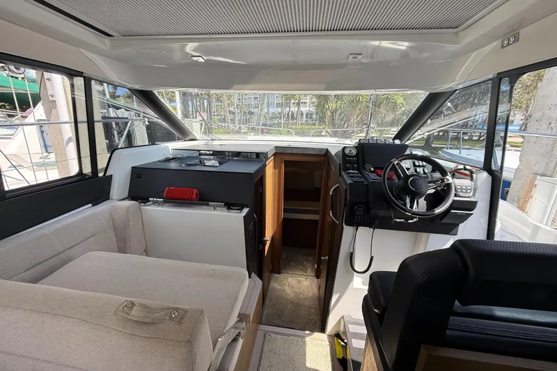  Yacht Photos Pics Interior of 2020 Jeanneau NC 37 boat with helm, seating, and cabin entrance.