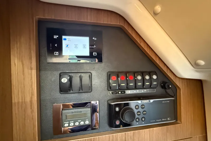  Yacht Photos Pics Control panel of 2020 Jeanneau NC 37 boat with switches and display screens.