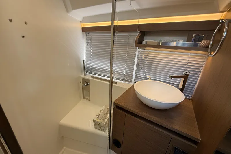  Yacht Photos Pics Modern bathroom interior of 2020 Jeanneau NC 37 yacht with sleek design and elegant fixtures.