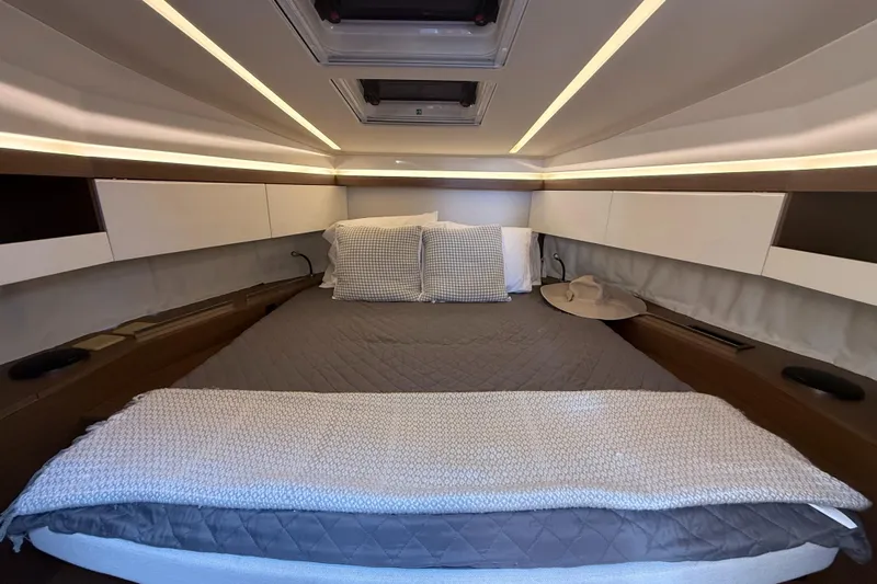  Yacht Photos Pics Luxurious cabin interior of 2020 Jeanneau NC 37 yacht with cozy bedding.