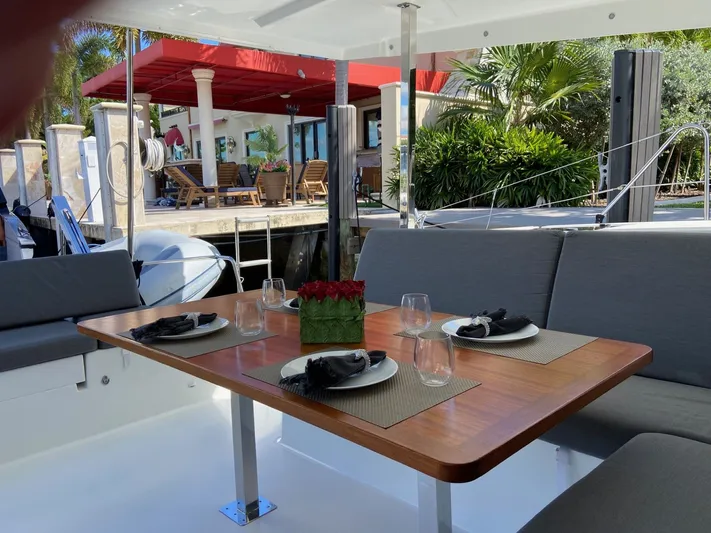Seas The Day Yacht Photos Pics Interior of Fountaine Pajot Isla 40 yacht, elegantly set dining table.