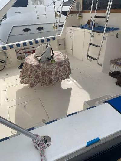 Lolly Yacht Photos Pics 1985 Ocean Yachts 55 Super Sport cockpit with table and seating.