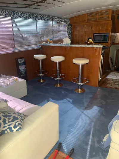 Lolly Yacht Photos Pics Interior of 1985 Ocean Yachts 55 Super Sport with bar stools and blue carpet.