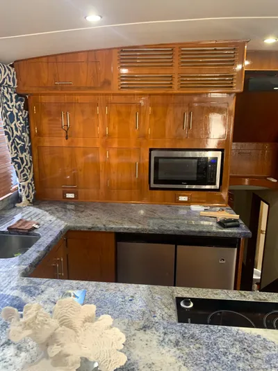 Lolly Yacht Photos Pics 1985 Ocean Yachts 55 Super Sport kitchen with wooden cabinets and granite countertops.