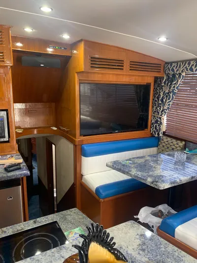 Lolly Yacht Photos Pics Interior of 1985 Ocean Yachts 55 Super Sport with blue and white seating, granite countertops.