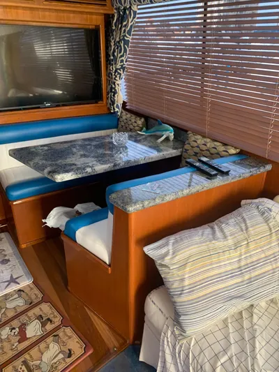 Lolly Yacht Photos Pics Interior of 1985 Ocean Yachts 55 Super Sport with dining area and TV.