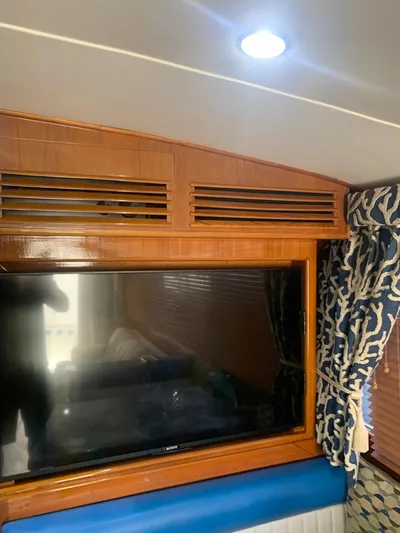 Lolly Yacht Photos Pics Interior of 1985 Ocean Yachts 55 Super Sport with TV and wooden paneling.